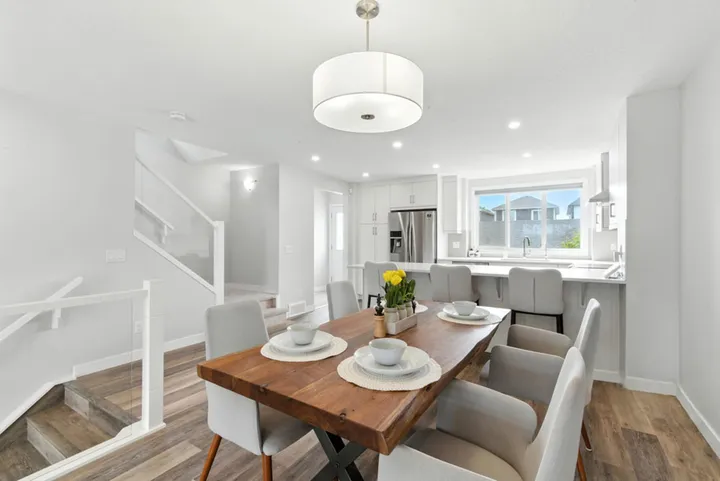 Open-concept dining area with a live-edge wood table next to the kitchen