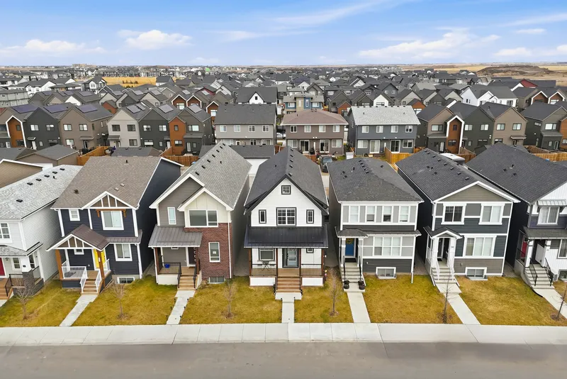 Aerial drone photo of a new-build Calgary subdivision with rows of homes