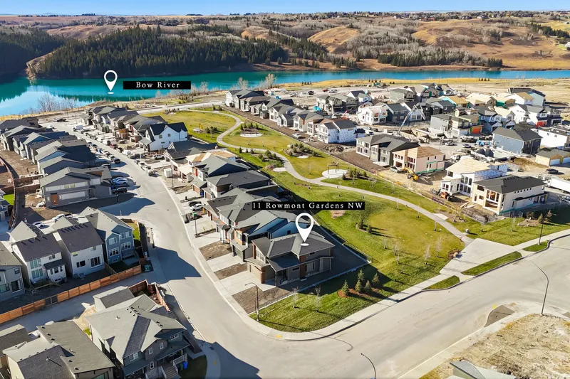Aerial drone photo of a Calgary acreage community with a pin marking the listing's distance to the Bow River